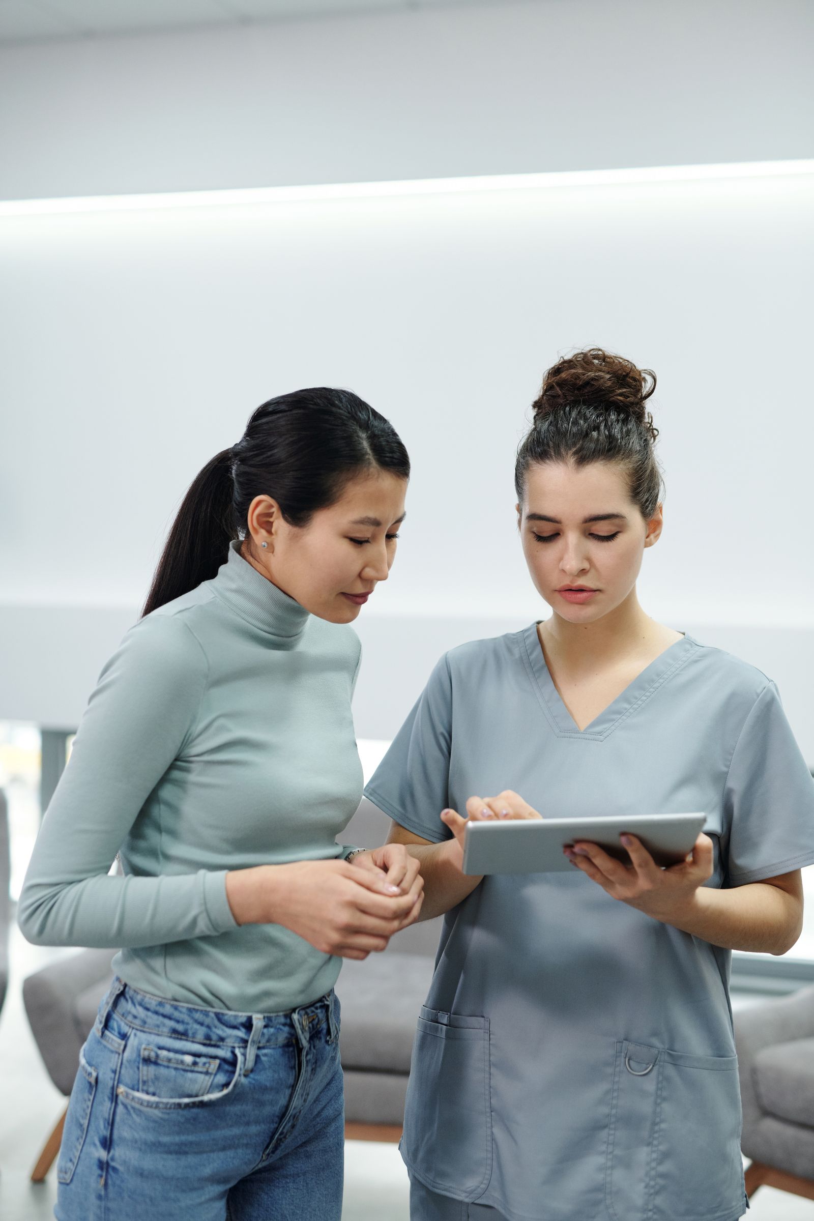 A clinician reviewing results on a tablet with a patient
