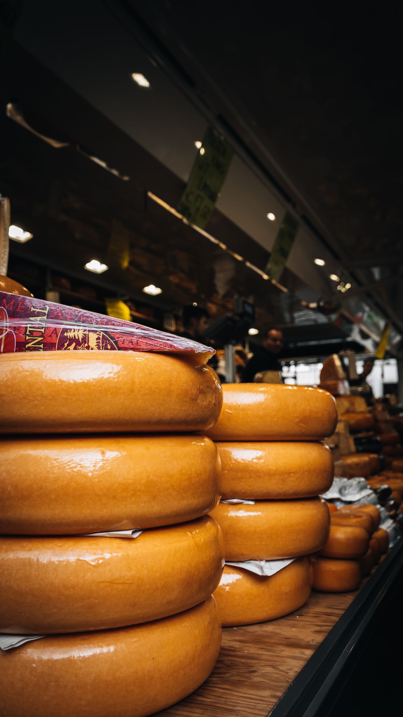 Stacks of cheese wheels at the Corner Store counter