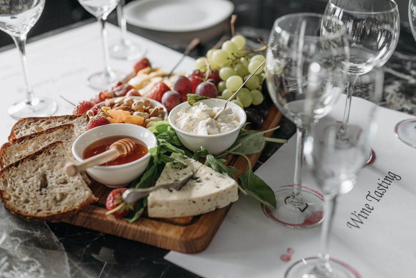 An abundant Italian deli board of cheeses, cured meats, bread and grapes