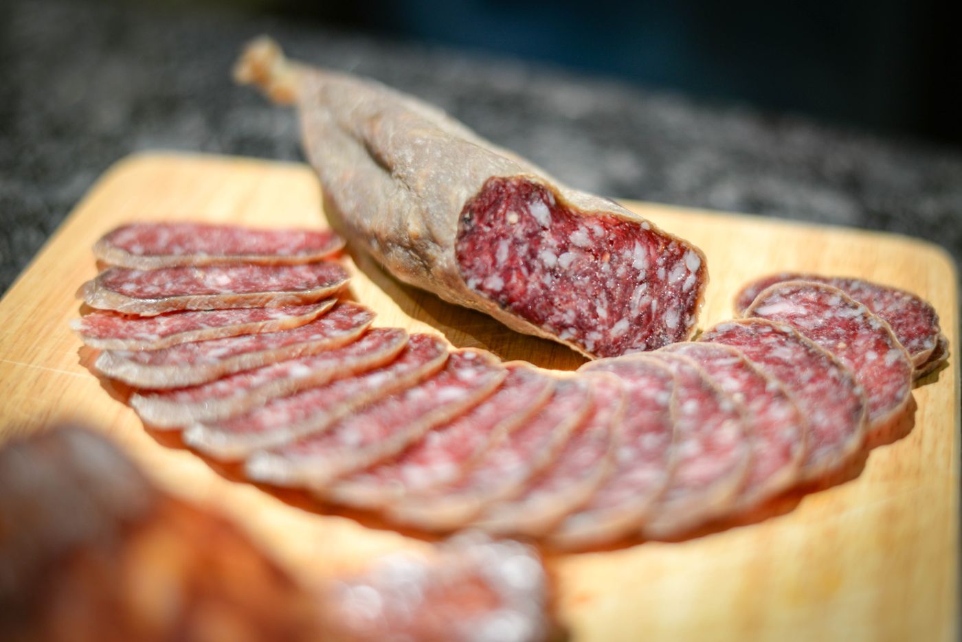 Sliced cured salami on a wooden board