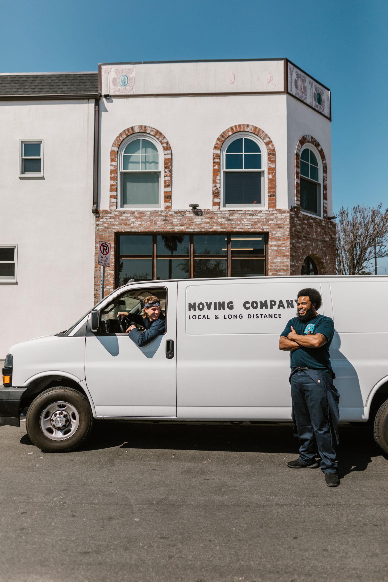 Two Northbound movers standing by their company van