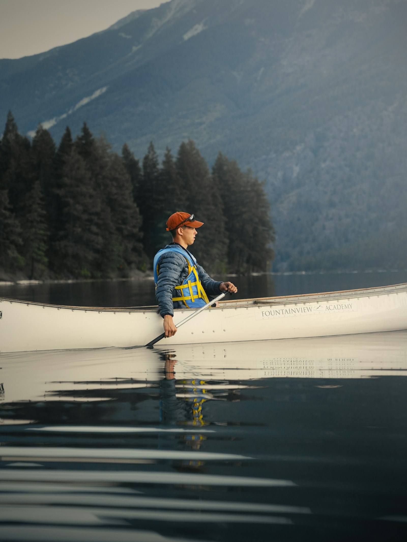 A canoe crossing open water in the morning