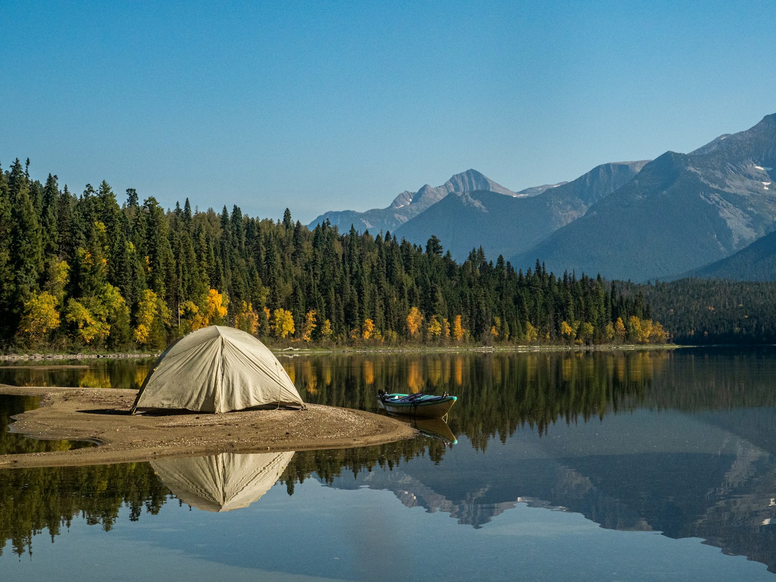A white safari tent pitched near the lake